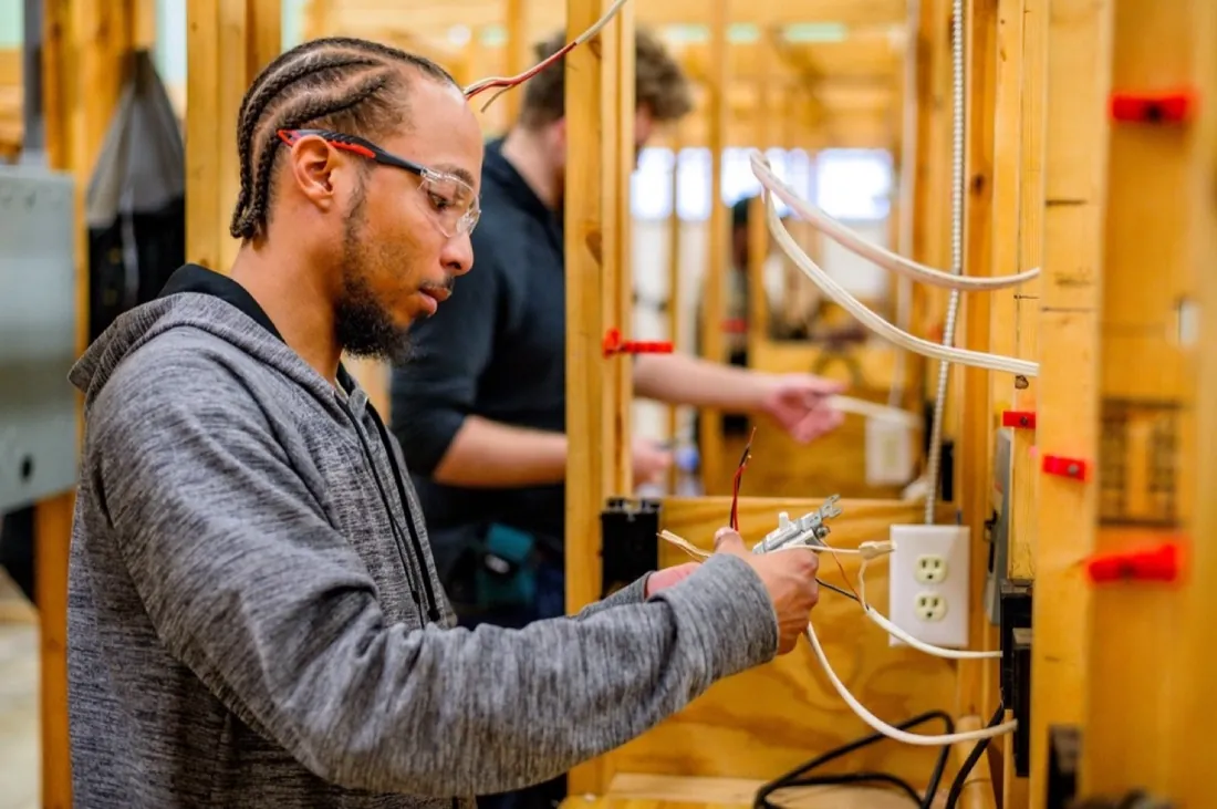An electrician wiring a new outlet